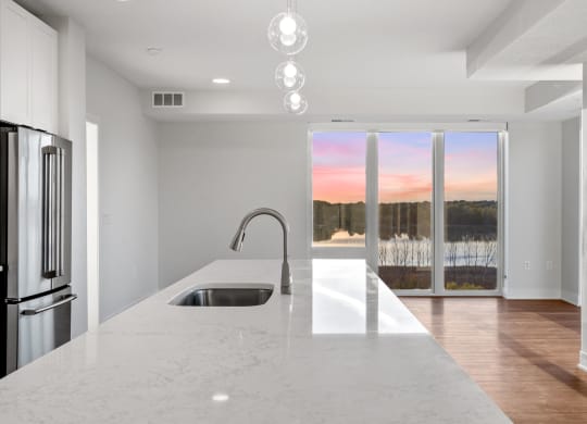 Expansive Kitchen Island with Overhead Lighting