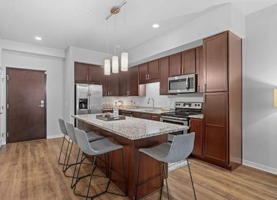 A kitchen with a table and chairs in the middle of it.