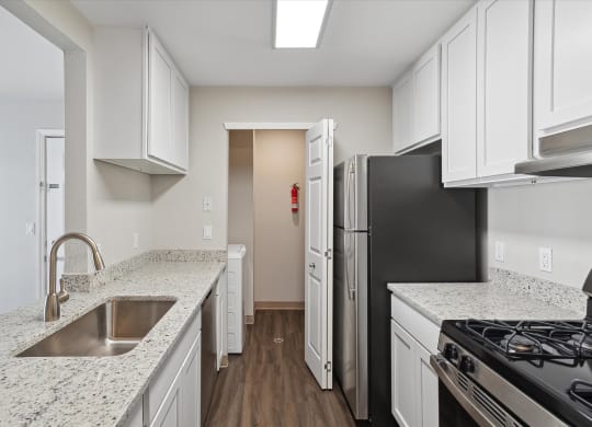 Kitchen with White Cabinetry and Stainless Steel Appliances