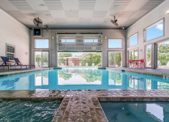 Indoor & Outdoor Pool Area With Garage Door That Goes Up