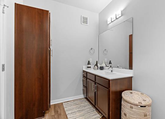 A bathroom with a wooden door and a white sink.
