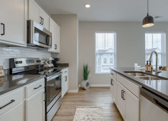 Kitchen with White Cabinetry and Stainless Steel Appliances