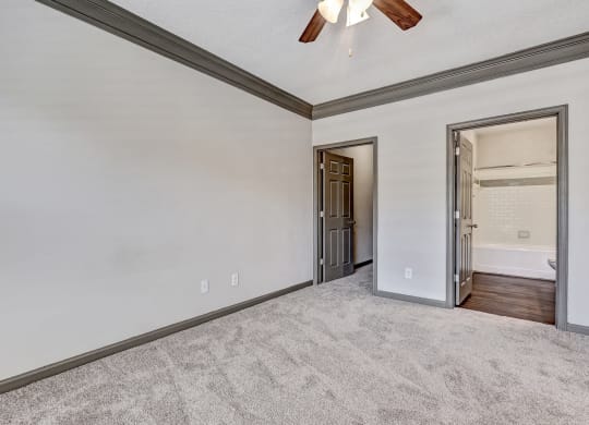 Carpeted Bedroom With Ceiling Fan & Light