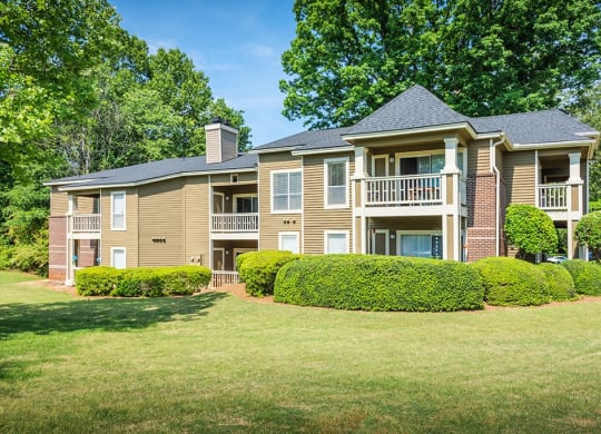 Exterior Of Apartment Homes Overlooking Lush Grass Area