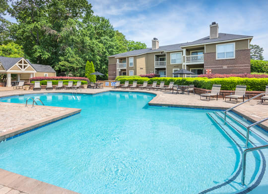 Large Outdoor Pool With Sun Lounge Chairs On The Sundeck