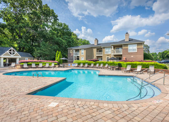 Outdoor Pool & Sundeck With Lush Landscaping