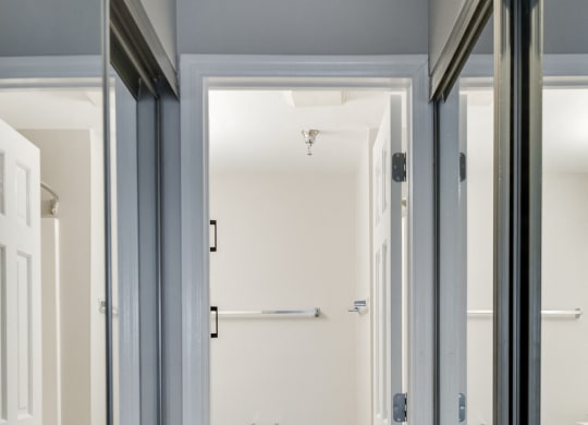 Mirrored Closets Leading to the Bathroom