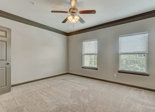 Spacious Carpeted Bedroom With Ceiling Fan & Light