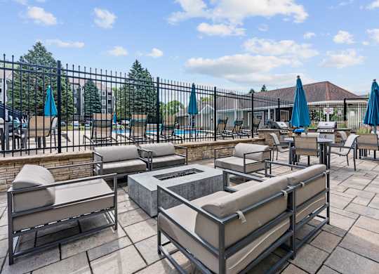A patio with a firepit and lounge.