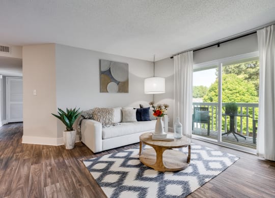 Living Room With Wood-Style Flooring, Light Grey Walls & White Trim