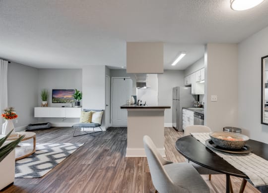 Open-Concept Living With Wood-Style Flooring & White Trim