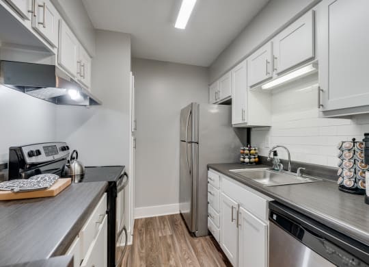 Kitchen With White Cabinetry & Stainless Steel Appliances