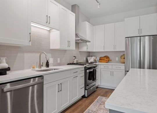 Gourmet Kitchen With Stainless Steel Appliances & White Cabinetry