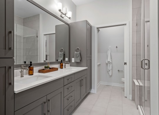 Primary Bathroom Featuring A Double Vanity With Built-In Storage