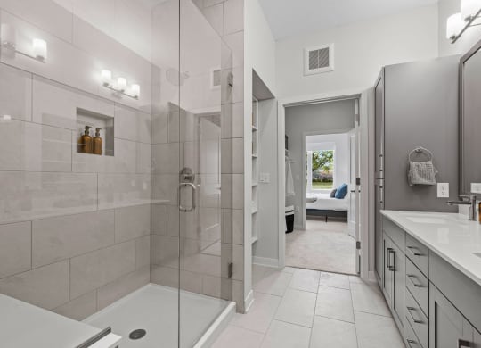 Primary Bathroom Featuring Glass Shower With Bench & Tiled Floor