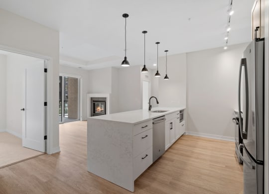 Expansive Kitchen Island with Overhead Lighting