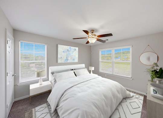 A bedroom with a large bed, expansive windows, and a ceiling fan.
