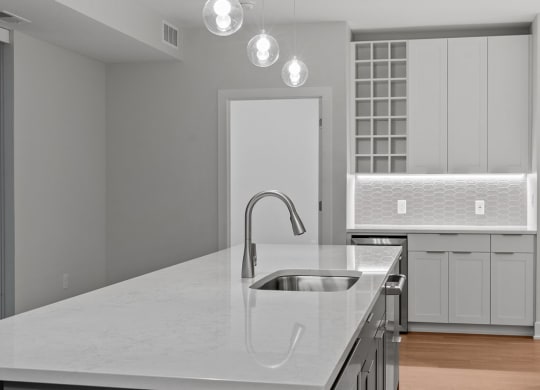 Expansive Kitchen Island with Overhead Lighting