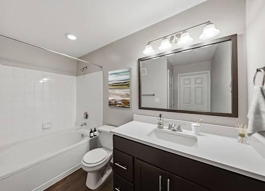 A bathroom with a white sink and a white toilet.