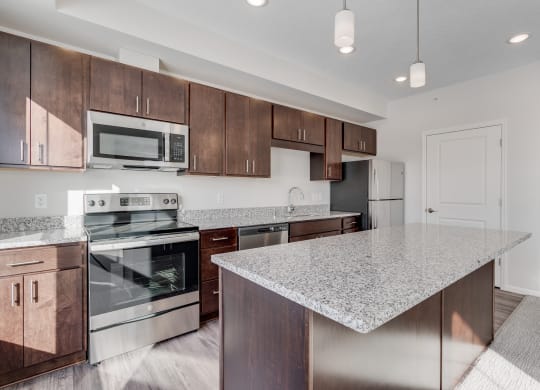 Kitchen Featuring Granite Countertops & Stainless Steel Appliances