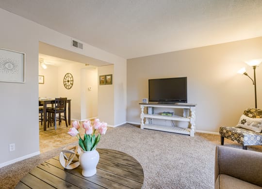 a living room with a tv and a table
