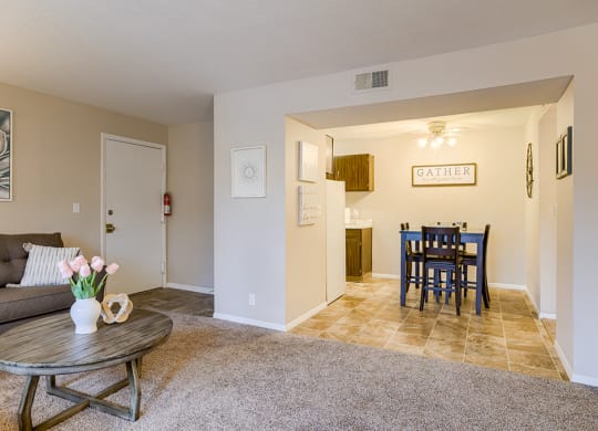 a living room and dining room with a table and a couch