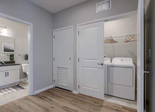 Closet With Washer & Dryer Featuring Built-In Shelves