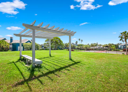 Large Open Green Space With Pergola & Bench