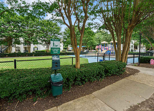 Dog waste station in front of the fenced-in dog park