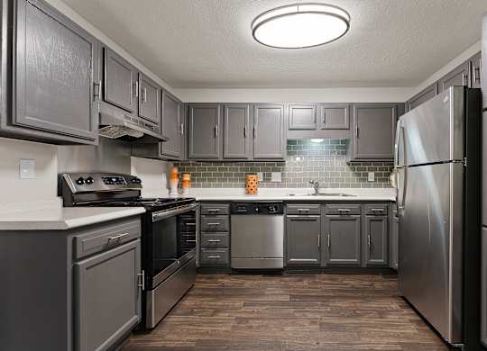 A kitchen with a refrigerator on the right.