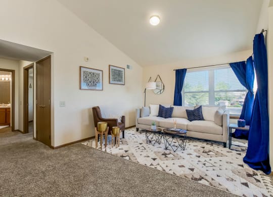 Open Living Room With Lots Of Natural Light & Vaulted Ceilings