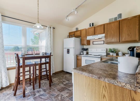 Kitchen With Vaulted Ceilings & White Appliances
