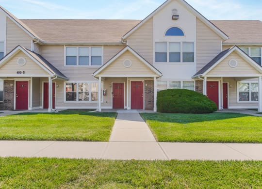 Lush Grass Area In Front Of Apartment Homes With Private Entrances