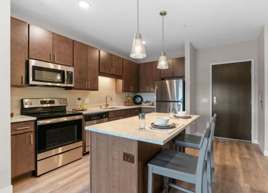 Kitchen with Dark Brown Cabinetry and Stainless Steel Appliances