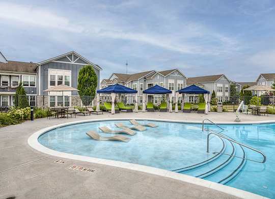 A swimming pool with a slide in the middle of it.
