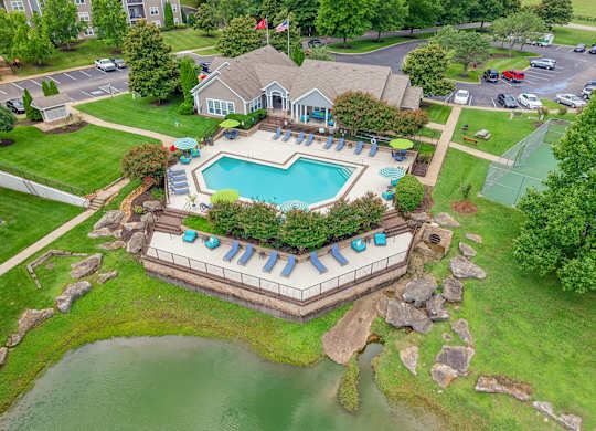 Aerial view of the pool, pond, and community