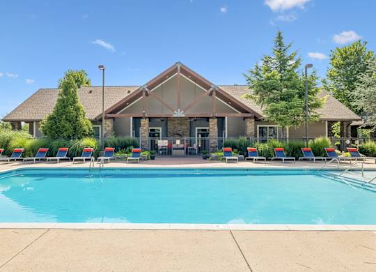 A large house with a pool in front.