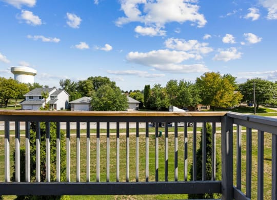 a view from the deck of a home with a water tower in the background