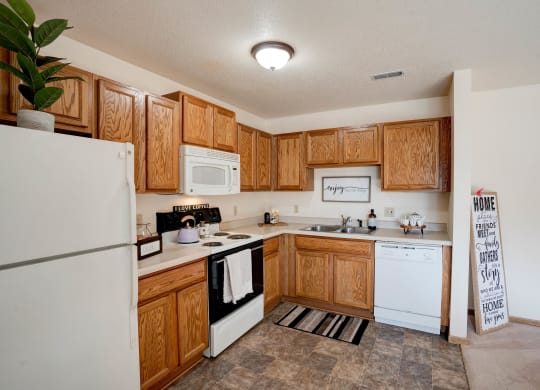 Fully-Equipped Kitchen With White Appliances