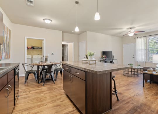 Expansive Kitchen Island with Overhead Lighting