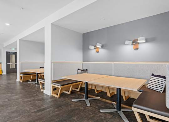 A conference room with a long table and chairs.