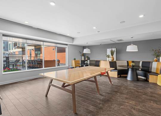 A modern dining room with a long table and chairs.