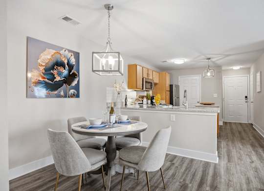 A dining room with a white table and chairs.