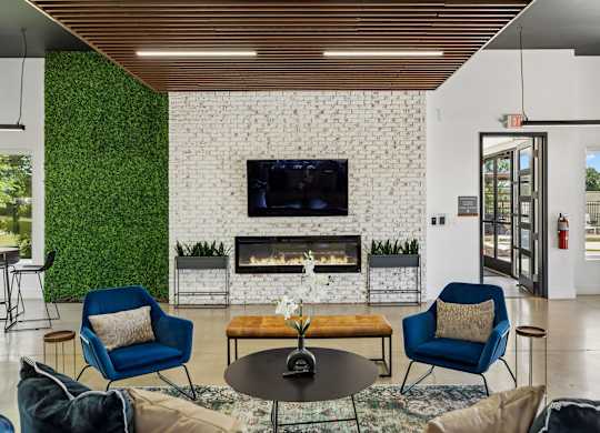 A living room with a fireplace and a TV mounted on the wall.