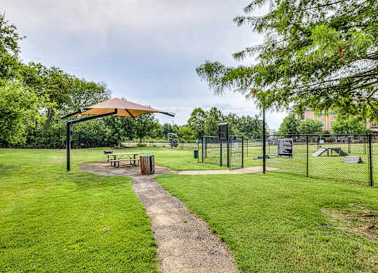 A park with a picnic table and a playground.