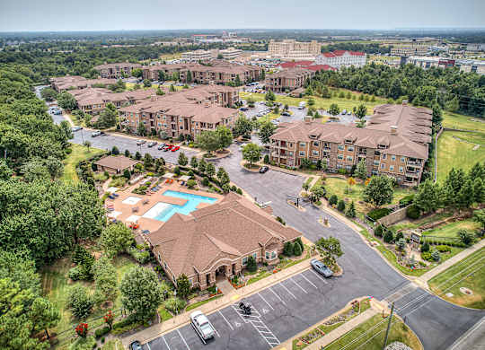 A bird's eye view of a residential complex with a swimming pool.