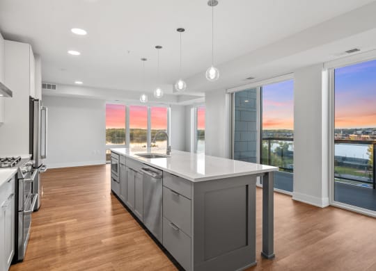Expansive Kitchen Island with Overhead Lighting