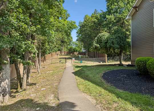A tree-lined walkway in a residential area.