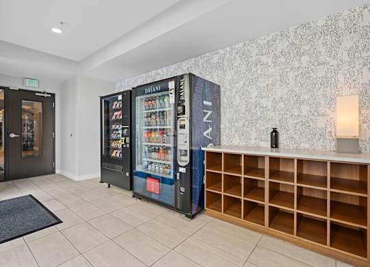 A room with a vending machine and a wall with a pattern.