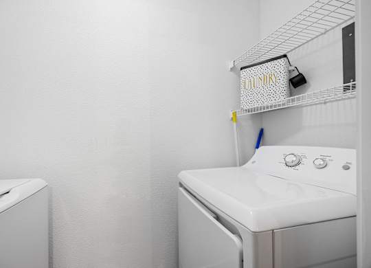 A white washing machine and dryer in a small laundry room.
